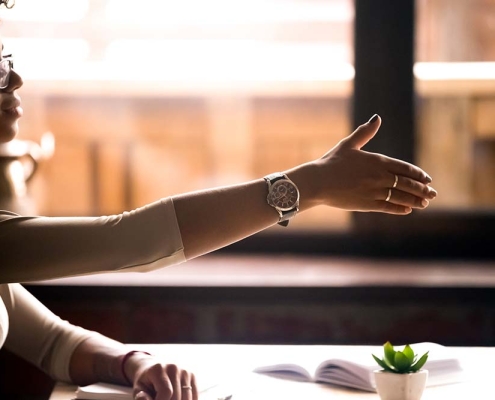 Black woman at work offering a handshake